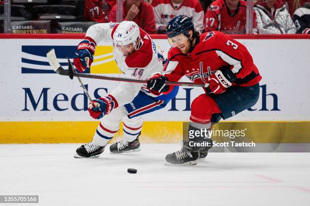 Nick Suzuki of the Montreal Canadiens and Nick Jensen of the Washington Capitals vie for the puck during the first period of the game at Capital One...