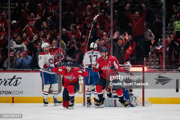 Nic Dowd of the Washington Capitals celebrates with Alex Ovechkin after scoring a goal against Jake Allen of the Montreal Canadiens during the first...