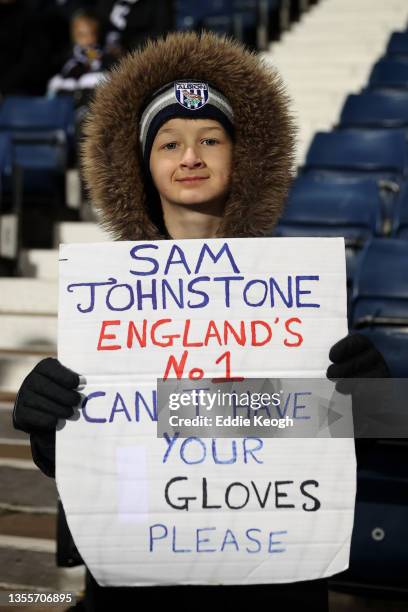 Fan of West Bromwich Albion shows his support also asking for the Goalkeeper gloves of Sam Johnstone on a sign during the Sky Bet Championship match...