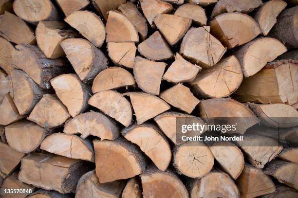 split firewood used to heat a farm house and the farm's greenhouses - firewood stock pictures, royalty-free photos & images