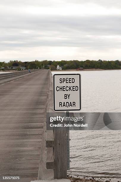 speed checked by radar sign on the wooden power point bridge that leads to duxbury beach in duxbury, massachusetts - duxbury, massachusetts stock pictures, royalty-free photos & images