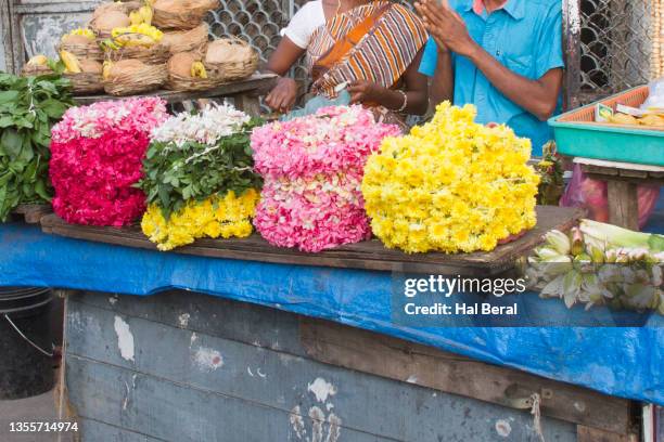 selling flowers as temple offerings in front of hindu temple - south indian food stock pictures, royalty-free photos & images