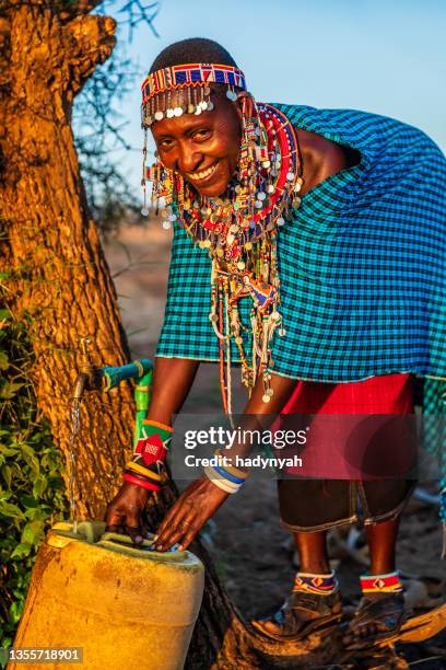 african woman from maasai tribe collecting water, kenya, east africa - a beautiful masai woman imagens e fotografias de stock