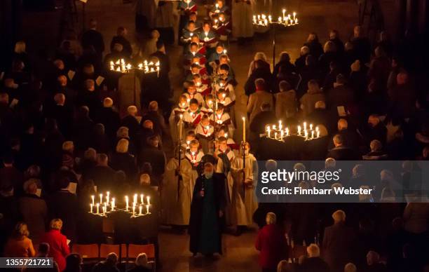 The interior of Salisbury Cathedral is illuminated by candles carried by choristers during the annual 'darkness to light' advent procession on...