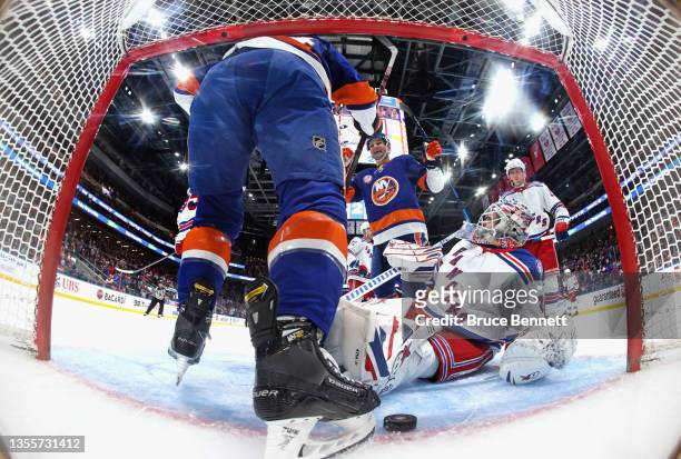 Andy Andreoff of the New York Islanders celebrates his third period goal against Igor Shesterkin of the New York Rangers along with Oliver Wahlstrom...