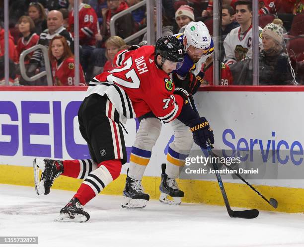 Kirby Dach of the Chicago Blackhawks pressures Colton Parayko of the St. Louis Blues behind the net at the United Center on November 26, 2021 in...