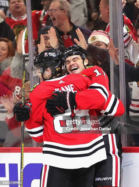 Patrick Kane and Alex DeBrincat of the Chicago Blackhawks celebrate after combining for the winning goal against the St. Louis Blues at the United...