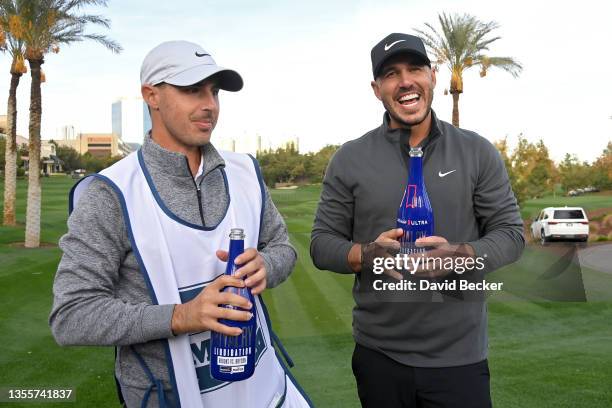 Brooks Koepka and his caddie Chase Koepka celebrate after winning Capital One's The Match V: Bryson v Brooks at Wynn Golf Course on November 26, 2021...