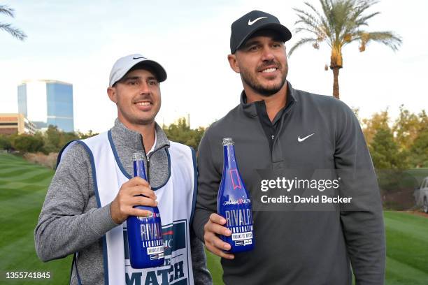 Brooks Koepka and his caddie Chase Koepka celebrate after winning Capital One's The Match V: Bryson v Brooks at Wynn Golf Course on November 26, 2021...