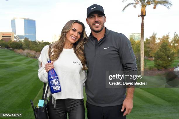 Brooks Koepka and his fiancée Jena Sims pose for photos during Capital One's The Match V: Bryson v Brooks at Wynn Golf Course on November 26, 2021 in...