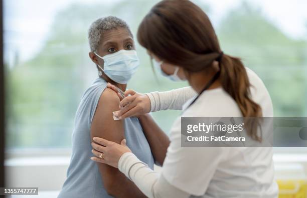 disinfecting before a vaccination - vaccine confidence stock pictures, royalty-free photos & images