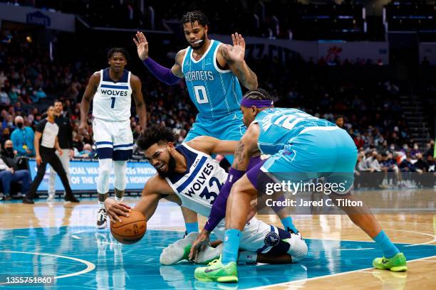 Karl-Anthony Towns of the Minnesota Timberwolves and P.J. Washington of the Charlotte Hornets battle for possession during the first half of the game...