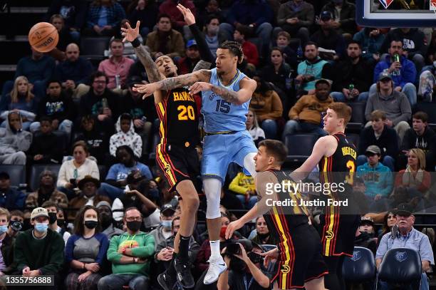 Brandon Clarke of the Memphis Grizzlies passes against John Collins of the Atlanta Hawks during the first half at FedExForum on November 26, 2021 in...