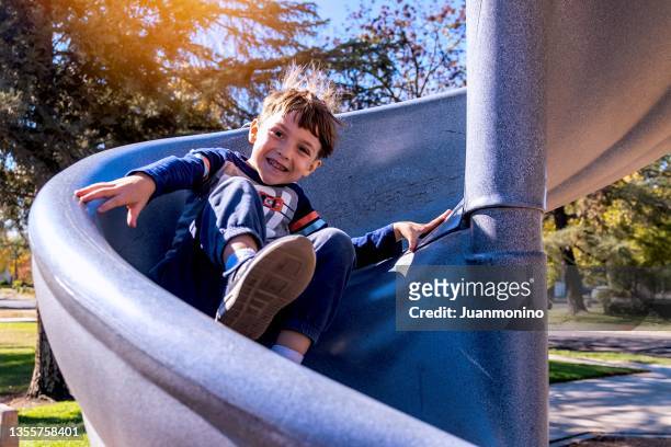 little boy having fun at the playground - child slide stock pictures, royalty-free photos & images