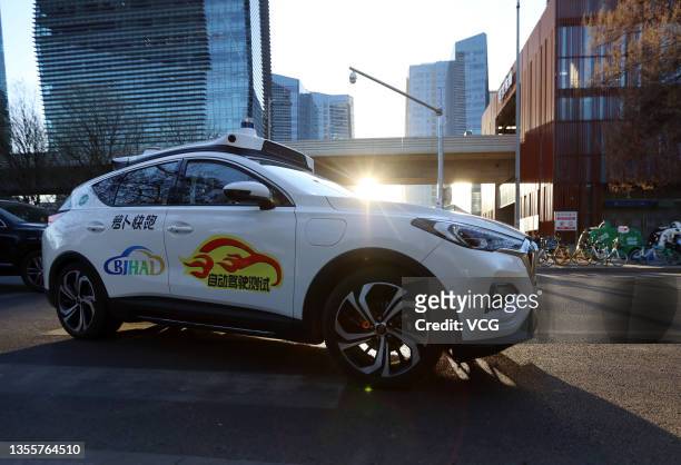 Baidu Apollo Go's commercialized autonomous robotaxi runs along a road after Beijing launched China's first-ever demonstration zone for commercial...