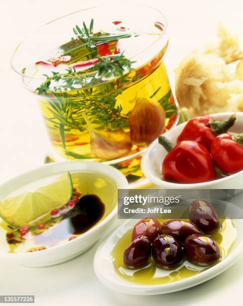 herb oil with olives and peppers - vinegar stock-fotos und bilder