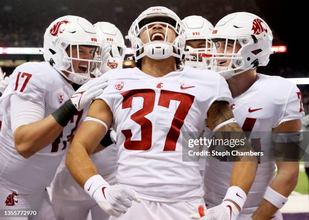 Justus Rogers of the Washington State Cougars celebrates his interception against the Washington Huskies during the third quarter at Husky Stadium on...