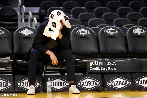 Injured Klay Thompson of the Golden State Warriors sits alone on the bench after the Warriors defeated the Portland Trail Blazers at Chase Center on...