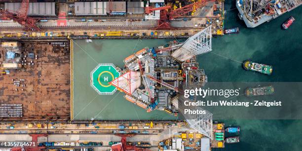 aerial shot of oil rig  leaving shipyard - boat singapore bildbanksfoton och bilder