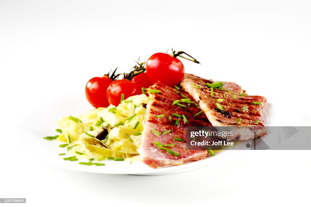 Sliced gammon with tomatoes and apple sauce