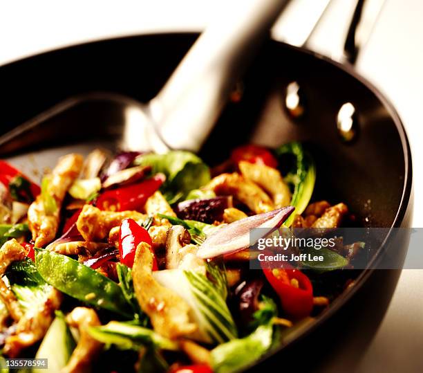 chicken and vegetable stirfry in wok - stirfry stock pictures, royalty-free photos & images