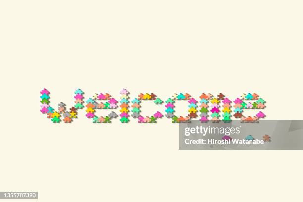 the word �“welcome” in a colorful human-shaped puzzle - panneau de bienvenue photos et images de collection