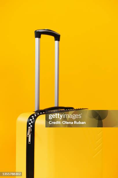 big suitcase on yellow background. - yellow suitcase stock pictures, royalty-free photos & images