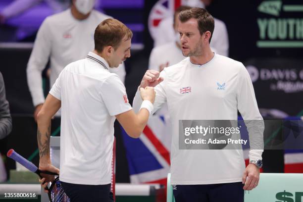 Daniel Evans of Great Britain celebrates a break point with Leon Smith, Captain of Great Britain during the Davis Cup match between Adrian Mannarino...