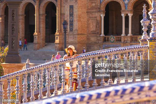 woman on the stairs of plaza de espana, seville, andalusia, spain, europe - francesco riccardo iacomino spain stock pictures, royalty-free photos & images