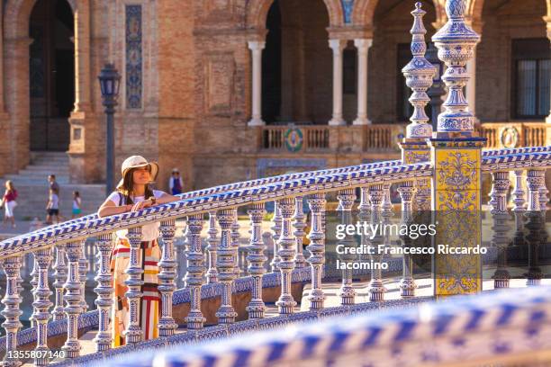 woman on the stairs of plaza de espana, seville, andalusia, spain, europe - seville tiles stock pictures, royalty-free photos & images
