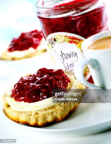 scone with cream & raspberry jam - scone stock pictures, royalty-free photos & images