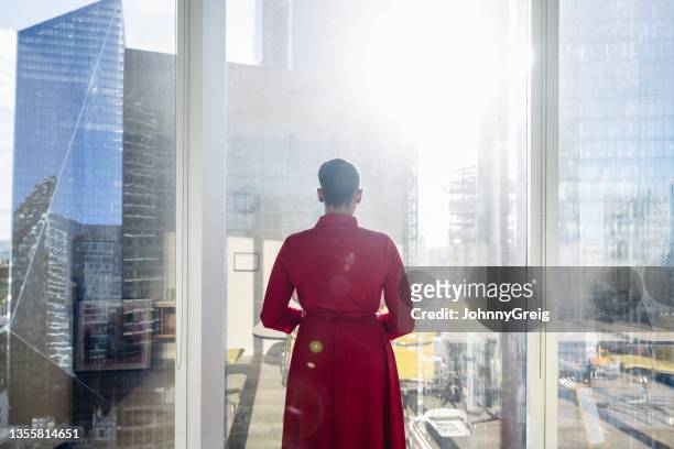 portrait of contemplative black businesswoman at window - back view bildbanksfoton och bilder