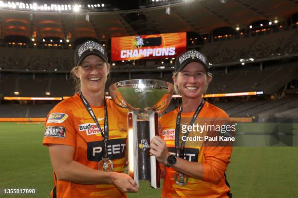 Sophie Devine and Beth Mooney of the Scorchers pose with the WBBL 07 Champions trophy after winning the Women's Big Bash League Final match between...