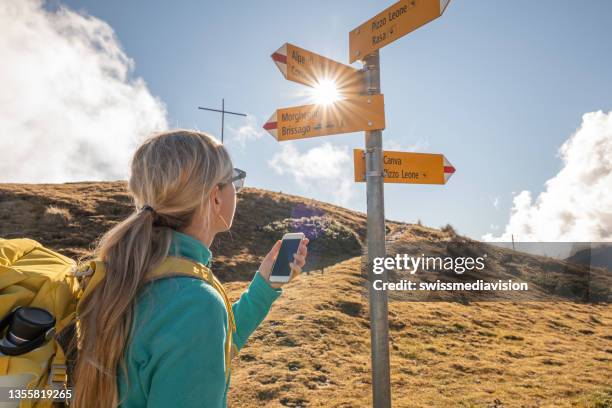 woman hiking on mountain ridge, clouds - aiming higher stock pictures, royalty-free photos & images