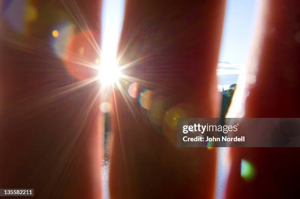 taking a picture through hand with the sun shining through - peeking over stock pictures, royalty-free photos & images