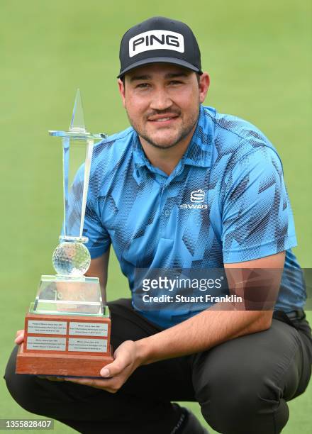Thriston Lawrence of South Africa celebrates with the trophy following victory during Day Three of the JOBURG Open at Randpark Golf Club on November...