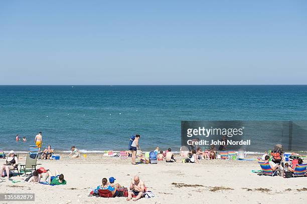 beachgoers and the atlantic ocean at duxbury beach, duxbury, massachusetts, usa 16 june 2010 - duxbury, massachusetts stock pictures, royalty-free photos & images