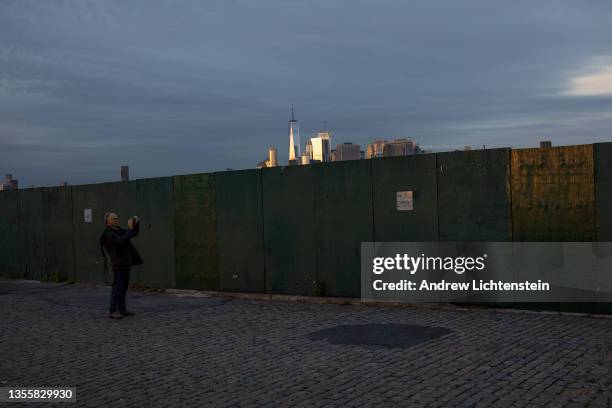 The last evening light catches the Manhattan skyline on November 25 as seen from the Red Hook neighborhood of Brooklyn, New York.