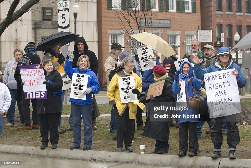 Protestors wave to cars that honk in passing at a labor rally in solidarity with the labor protests (happening in Wisconsin) in Springfield, Massachusetts, USA on Monday, 4 April 2011. A coalition of labor unions and citizens groups, such as Jobs with Jus