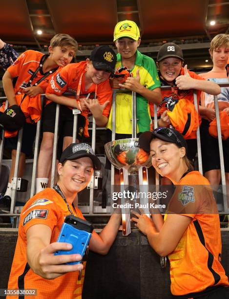 Taneale Peschel and Piepa Cleary of the Scorchers pose for photos with young supporters during the Women's Big Bash League Final match between the...