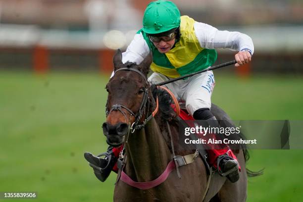 Charlie Deutsch riding Cloudy Glen clear the last to win The Ladbrokes Trophy Chase at Newbury Racecourse on November 27, 2021 in Newbury, England.