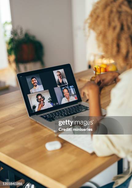 anonymous woman having a conference call on her laptop - conference call imagens e fotografias de stock