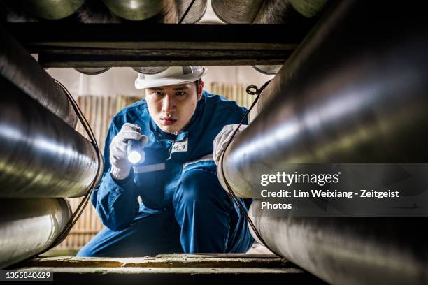 technician inspecting pipeline