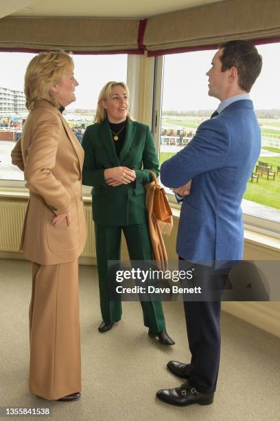 Madeleine Lloyd Webber, Isabella Lloyd Webber and Jimmy Carr attend the Ladbrokes Winter Carnival on Ladbrokes trophy day at Newbury Racecourse on...