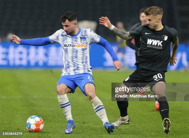 Marco Richter of Hertha BSC is closed down by Niklas Dorsch of FC Augsburg during the Bundesliga match between Hertha BSC and FC Augsburg at...
