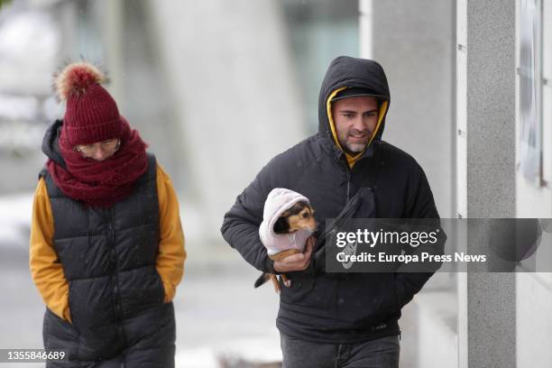 Man carries a dog on November 27 in Pedrafita do Cebreiro, Lugo, Galicia, Spain. This snow is the result of the Arwen squall. Fourteen autonomous...