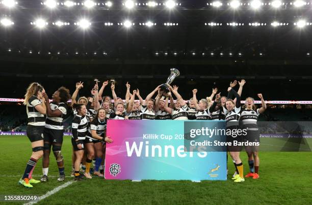 Barbarians players celebrate with the Killik Cup following victory in the Killik Cup match between Barbarians Women and Springbok Women's XV at...