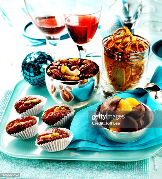 party snacks - crisps, nuts and dried fruit - christmas party canapes stock pictures, royalty-free photos & images