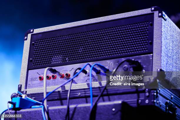 low angle view of back view of concert audio amplifier and cables on a blurred background - guitar amp stock-fotos und bilder