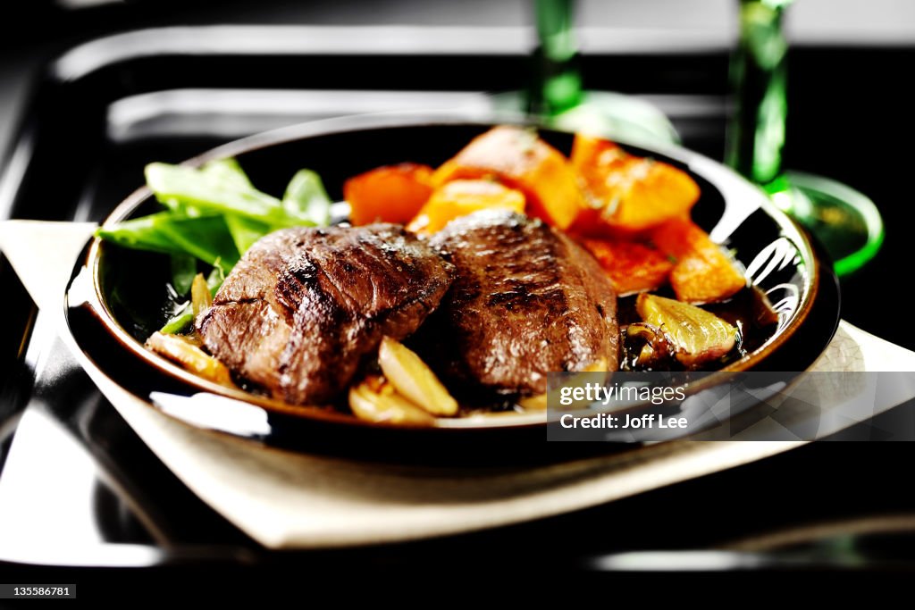 Venison steaks with roasted vegetables